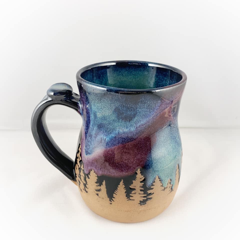 Northern lights with vinyl resist mug with blue-purple aurora glaze and forest silhouette (Cindy Hiebert