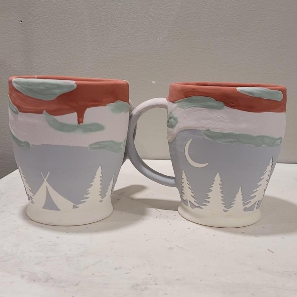 Vinyl resist forest and moon decals on mugs before firing  (Anna Zeilstra)