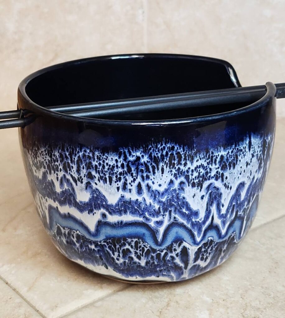 Indigo Float and Snow over Obsidian layered on porcelain bowl by Kathy McGuire fired to Cone 6 with flowing cobalt blue and white glaze movement