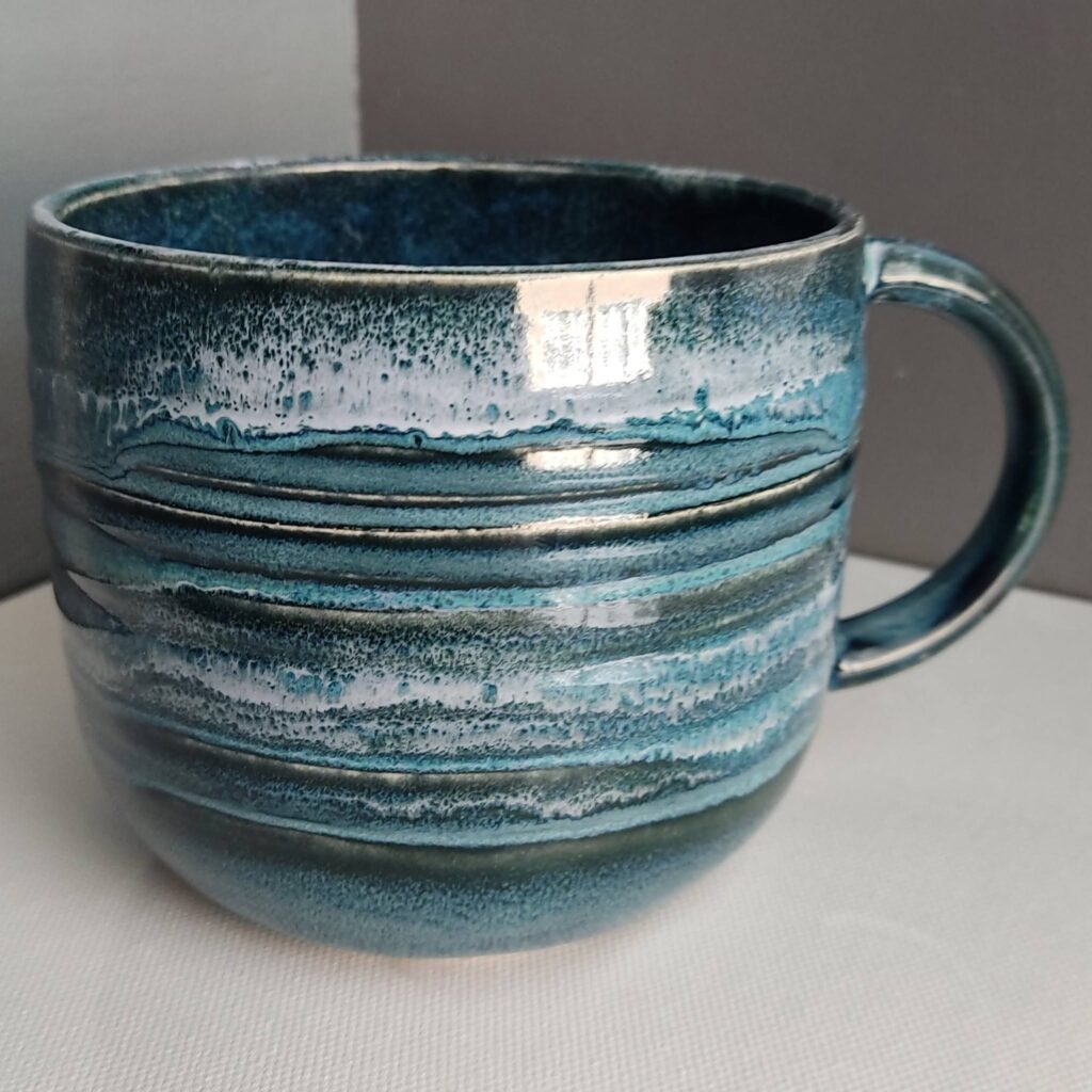 Handle detail of Snow over Teal Drift over Obsidian ceramic mug