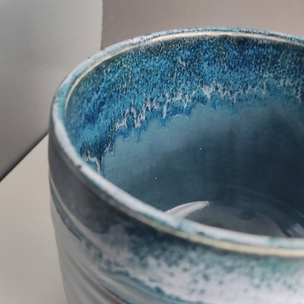 Interior of Snow over Teal Drift over Obsidian glazed mug showing blue glaze surface